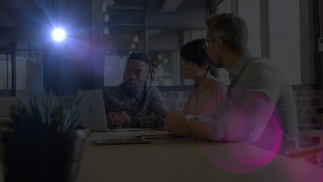 Animation of light spots over diverse business people working in office