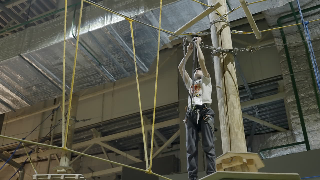Child enjoying an indoor ropes course adventure