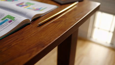 open textbook with diagrams on wooden table