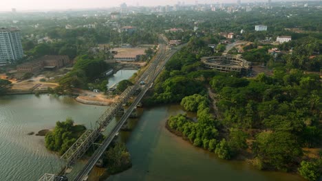 aerial drone shot of a train crossing a railway bridge over the ocean