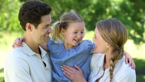 Padres-Felices-Con-Su-Niña-En-El-Parque