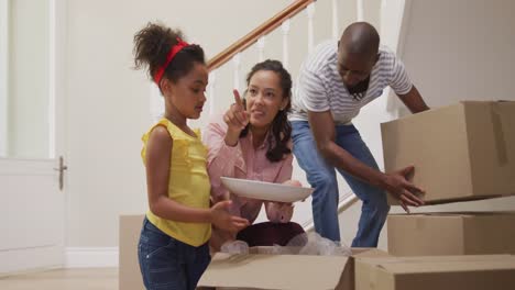 african american couple and their daughter moving into new house