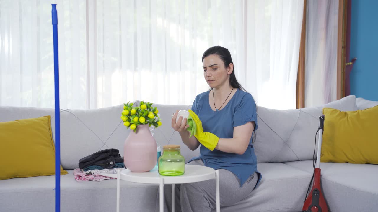 가정 용품에서 먼지를 청소하는 여성.
