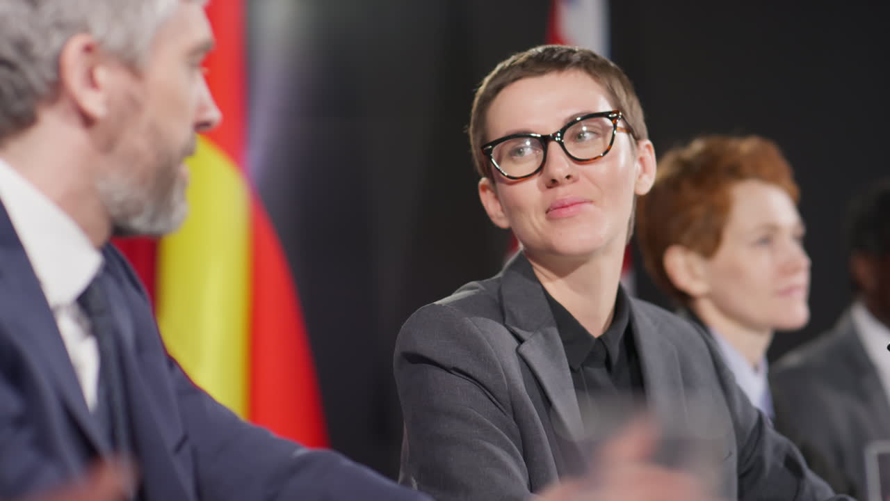 Female Politician Talking with Colleague at Press Conference