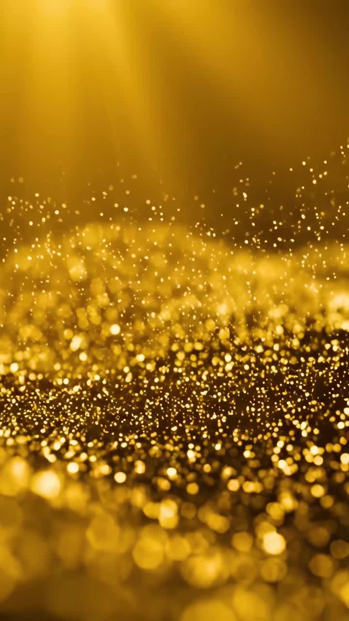 Abstrakte gyldne glitterpartikler, der flyder med bokeh-effekt.