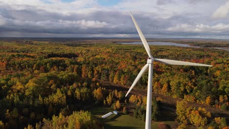 wind turbine working in autumn colored woodland area of usa, aerial view