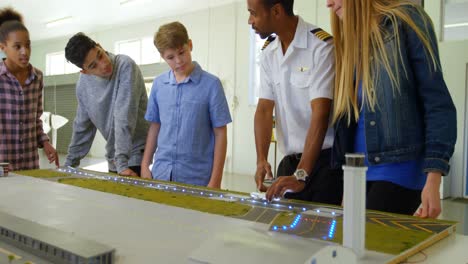 Male pilot training about model plane to kids 4k