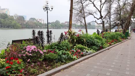 flower-lined walkway beside a tranquil river