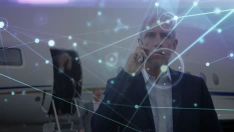 animación del procesamiento de datos sobre un hombre de negocios caucásico hablando por teléfono inteligente