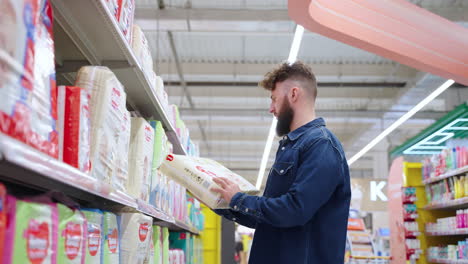 man shopping for diapers in a supermarket