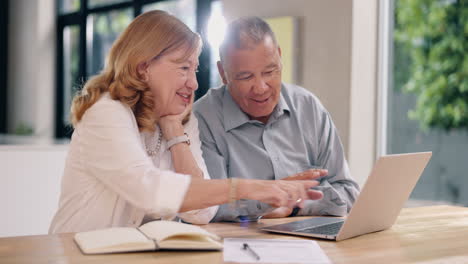 senior couple using laptop together