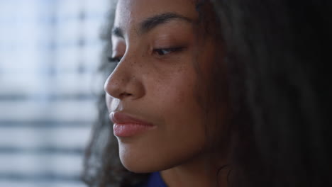 Young-black-hair-woman-looking-thinking-about-business-career-in-window-office