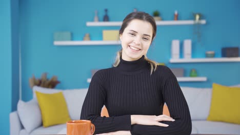 Portrait-of-happy-young-entrepreneur-woman-working-in-her-home-office.