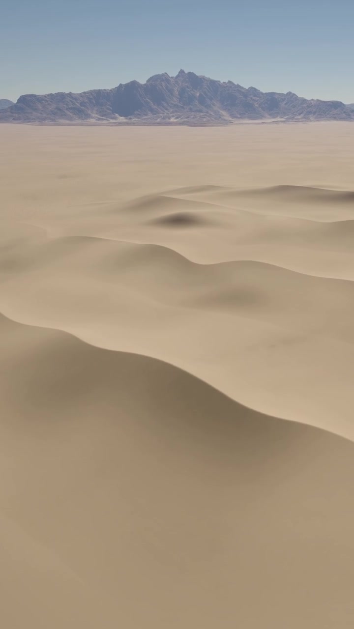Vaste dune di sabbia sotto un cielo azzurro e limpido con viste di montagne distanti nel deserto.