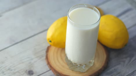 glass of milk and lemon on table ,