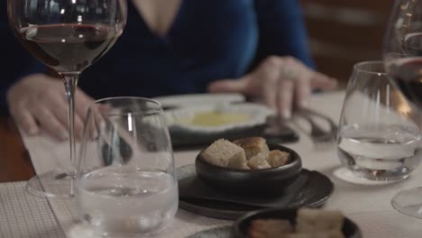 a lady tastes olive oil in a restaurant