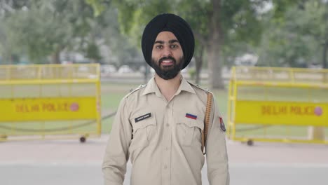 happy sikh indian police man showing thumbs up