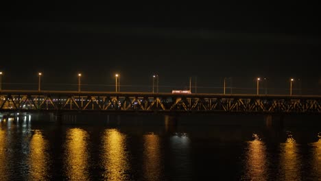 night view of the long bridge crossing a wide river