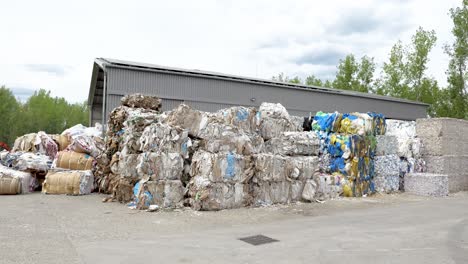 bales of paper, cardboard waiting to be processed at recycling center