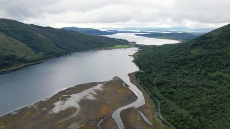 Low-water-on-tidal-inlet-Loch-Creran-between-the-green-hills-in-Scotland-on-a-cloudy-day