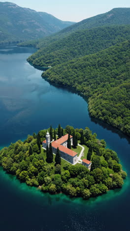 aerial view of a monastery on an island in a lake