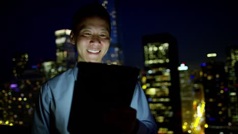 portrait of ethnic businessman video call at night