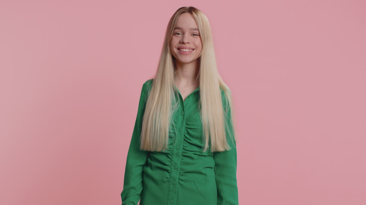 Cheerful funny bully young woman showing tongue making silly faces fooling around joking teasing