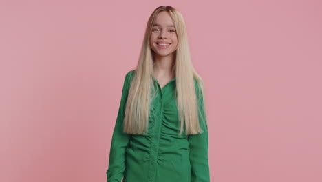 cheerful funny bully young woman showing tongue making silly faces fooling around joking teasing