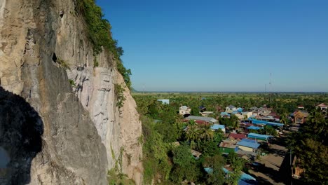 Giant-Buddha-carved-in-mountain-rock-face-at-Phnom-Sampov,-Cambodia