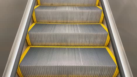 Slow-Moving-Metal-Escalator-Stairs-In-Sunlight