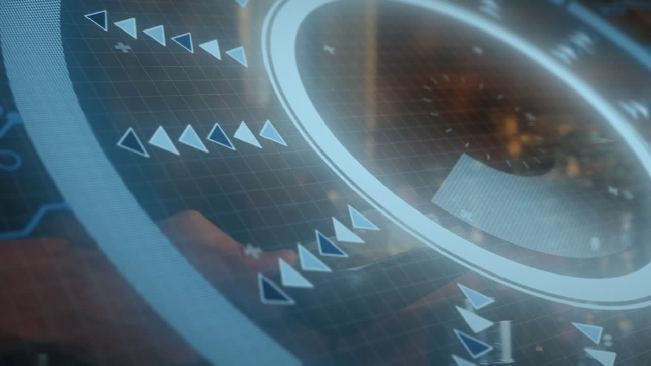 Designer using tech interface, showing glowing circular ring with arrow pointers and grid overlay