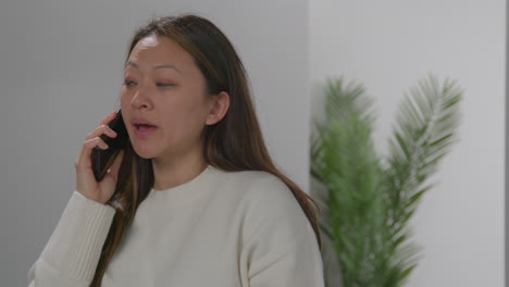 Angry-Anxious-Or-Stressed-Woman-Having-Argument-On-Mobile-Phone-At-Work-In-Office-Building-4