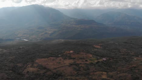 Pull-front-over-fields-with-light-at-cloudy-sunset-in-Colombia