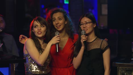 multi ethnic women singing together