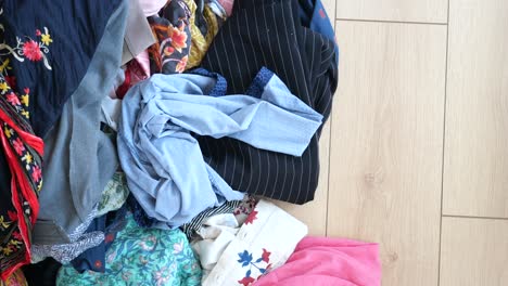 pile of clothes on a wooden floor