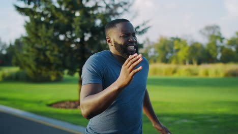 tired athlete jogging in park.sportsman feeling bad during run marathon outdoors