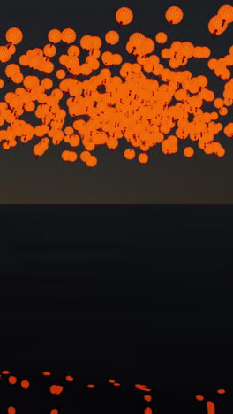 muchas linternas naranjas en el cielo nocturno sobre el agua
