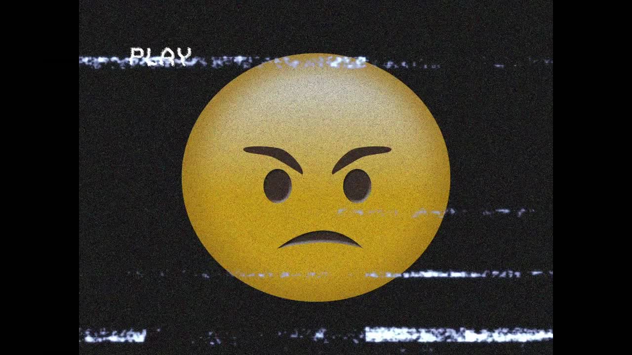Digital animation of vhs glitch effect over angry face emoji against black background