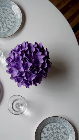 purple hydrangea centerpiece on a white dining table