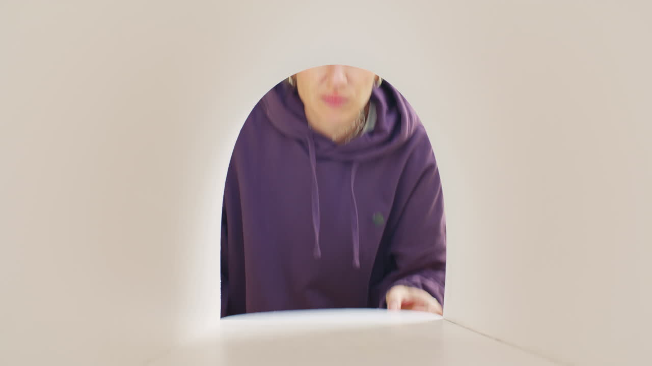 Young Woman Looking into Empty Mailbox with Disappointment