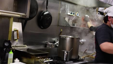 chefs working together in a steamy kitchen