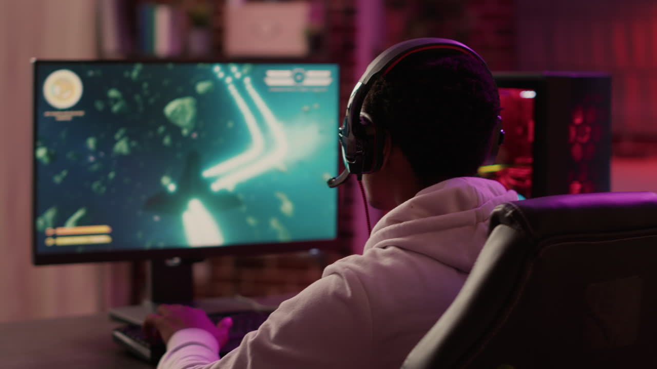 Over shoulder view of gamer feeling unhappy after losing difficult level in online space shooter on gaming pc