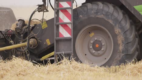 Close-up-shot-of-a-harvest-machine-slowly-moving-on-a-grain-field