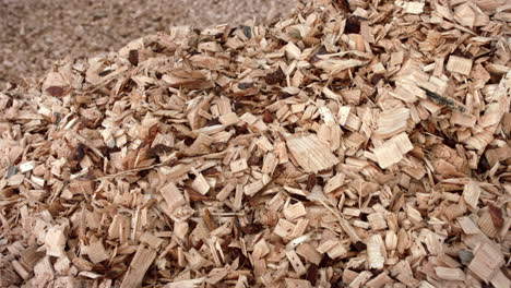 sawdusts falling into heap during process of woodworking. wooden sawdust