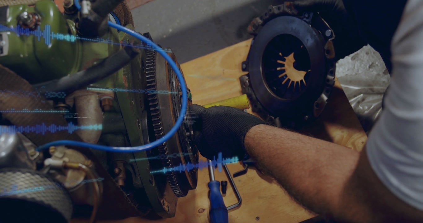 Tech checking bolts, removing clutch plate from flywheel for auto while waveform overlay tracking