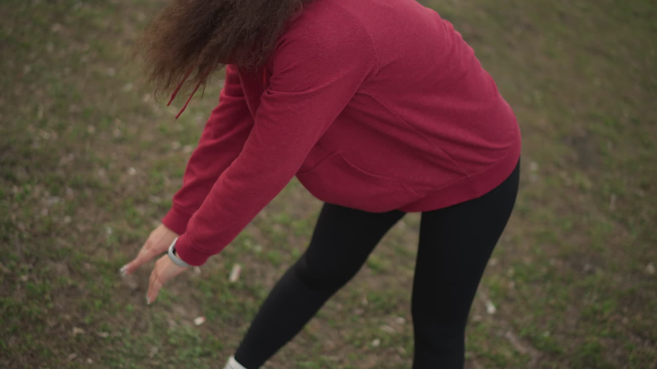 Deep Breath Posture, Focused Yoga Stretch Session, Woman Engages In Yoga On Grass With Concentration, Individual Performs Forward Bend Outdoors Focusing On Mindful Breathing And Posture