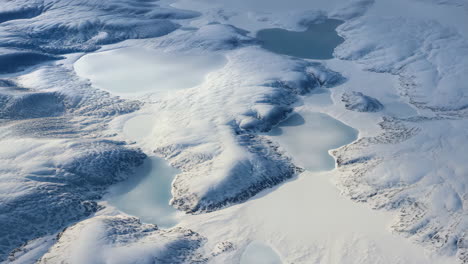 aerial view of arctic winter landscape with frozen lakes