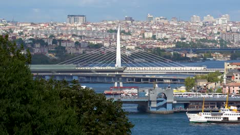 golden horn metro bridge in istanbul, turkey, ferry traffic, cars, city skyline, bosphorus