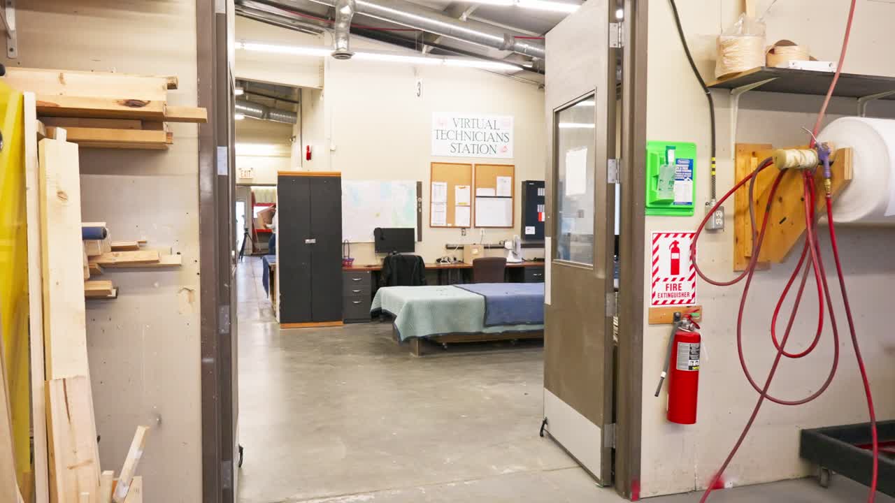 Walkthrough captures industrial furniture repair shop with tools and lighting