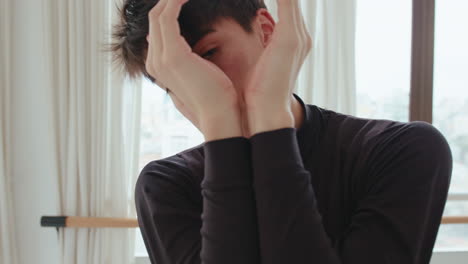 young male dancer looking at camera and performing arm moves